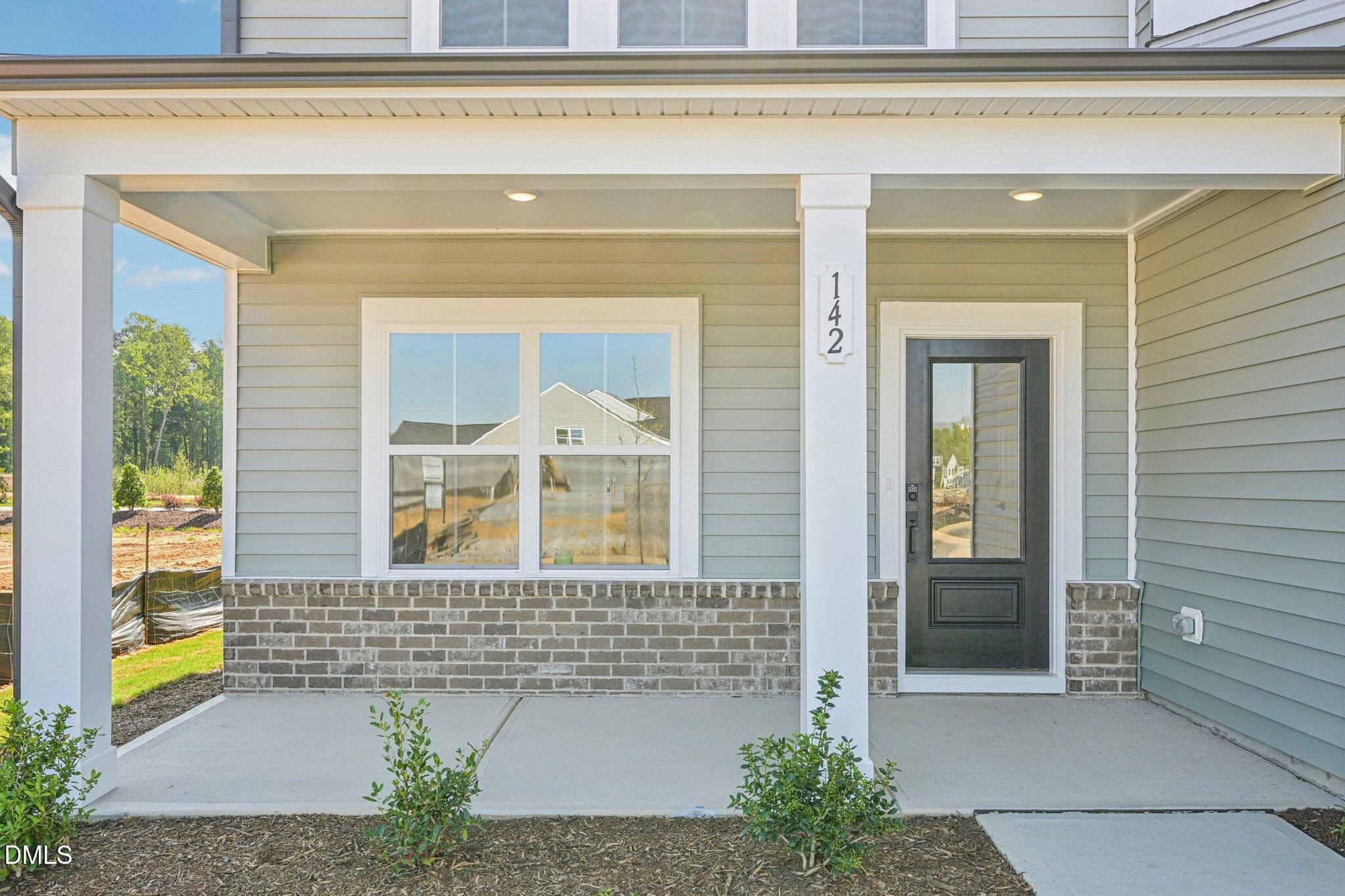 142 North Harvest Rdg Way, Unit HOMESITE 310 Clayton, NC 27520 - Photo 5 of 43 a front view of a house with a porch
