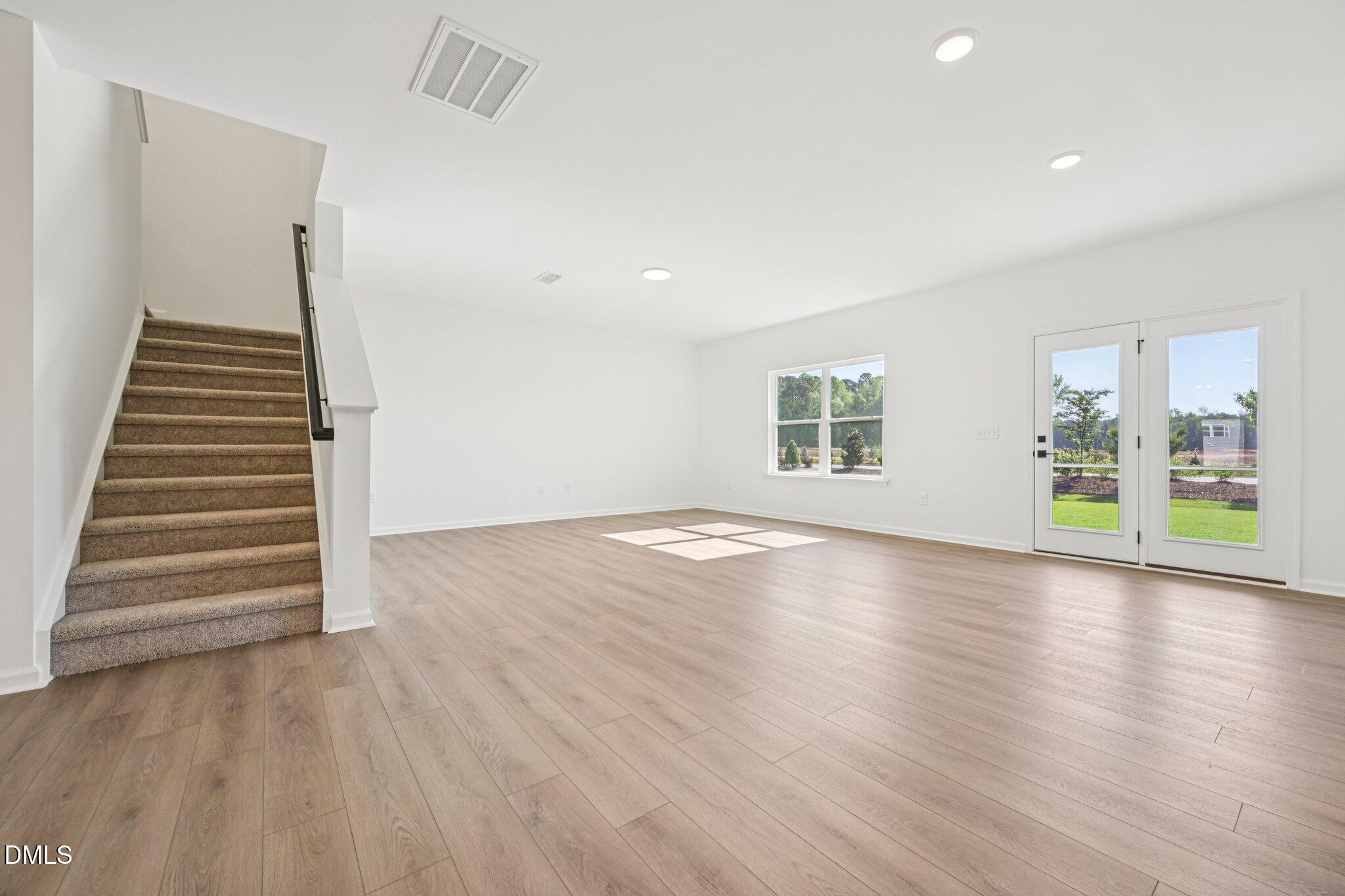 142 North Harvest Rdg Way, Unit HOMESITE 310 Clayton, NC 27520 - Photo 9 of 43 wooden floor in an empty room with a window