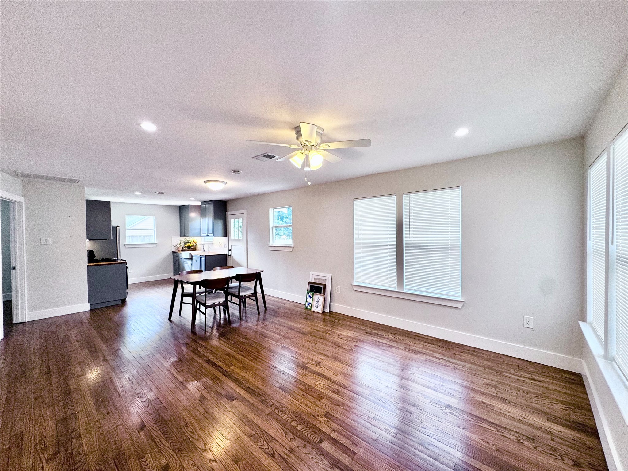 a view of a a dining room with furniture window and wooden floor