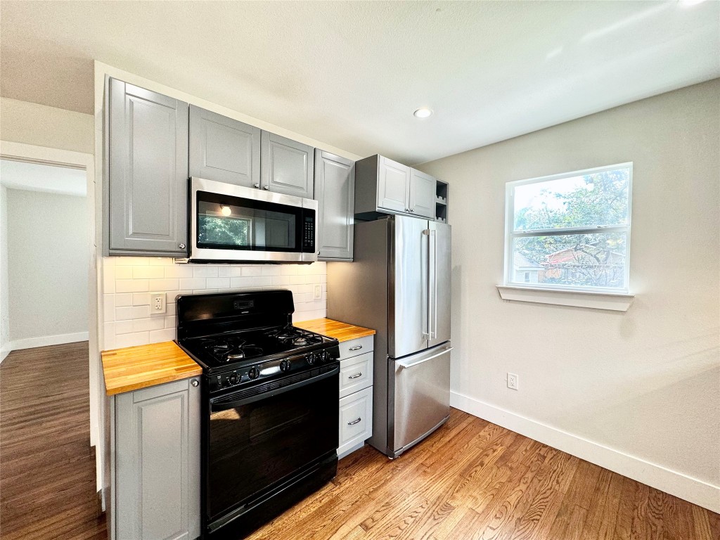 1035 Louise Street Houston, TX 77009 - Photo 10 of 28 a kitchen with a refrigerator stove and microwave