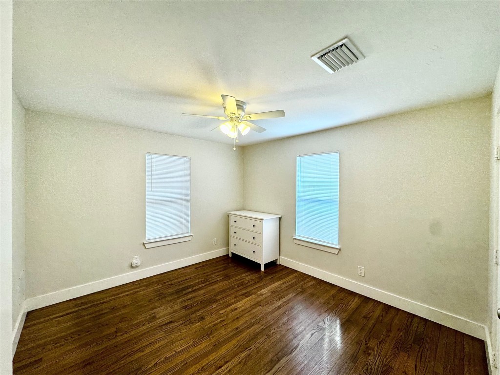 1035 Louise Street Houston, TX 77009 - Photo 11 of 28 an empty room with wooden floor and windows