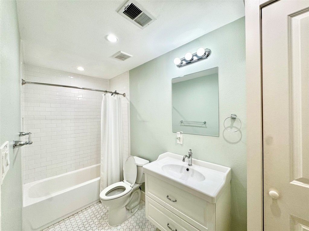 1035 Louise Street Houston, TX 77009 - Photo 17 of 28 a bathroom with a sink toilet tub and shower