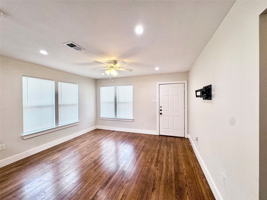 1035 Louise Street Houston, TX 77009 - Photo 5 of 28 wooden floor in an empty room with a window
