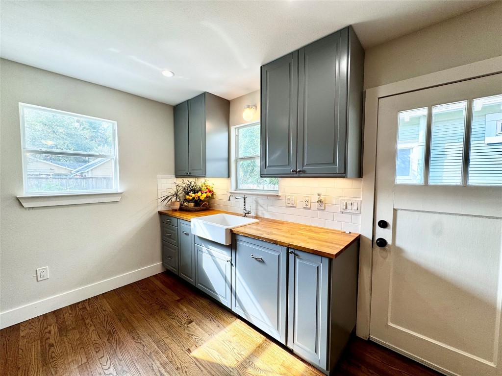 1035 Louise Street Houston, TX 77009 - Photo 9 of 28 a kitchen with granite countertop wooden floors and sink
