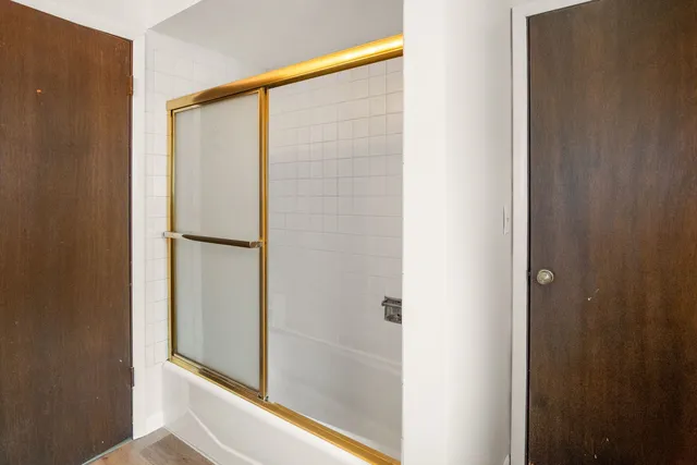 a bathroom with a glass shower door