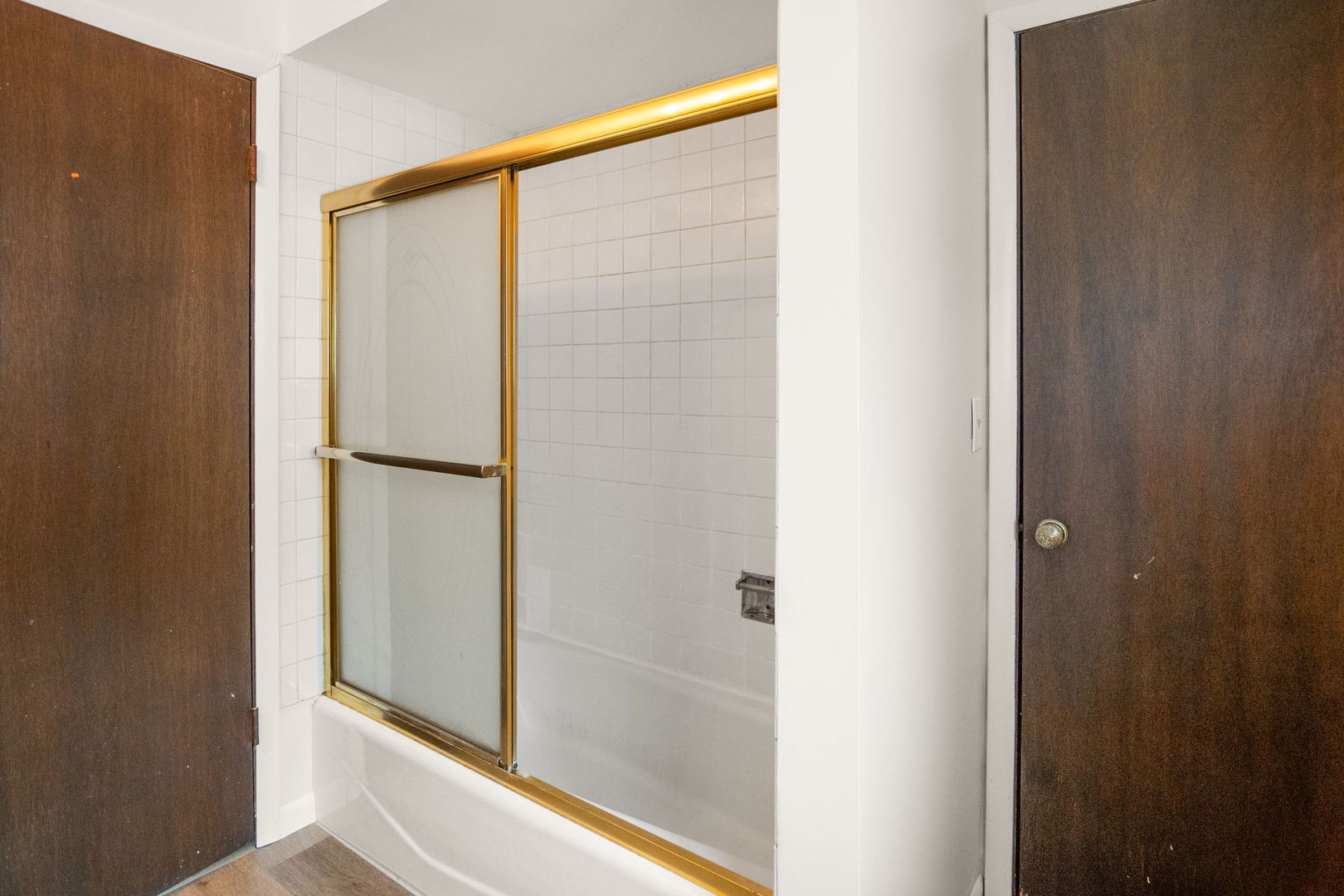 S064 Calvin Court Wheaton, IL 60187 - Photo 17 of 25 a bathroom with a glass shower door