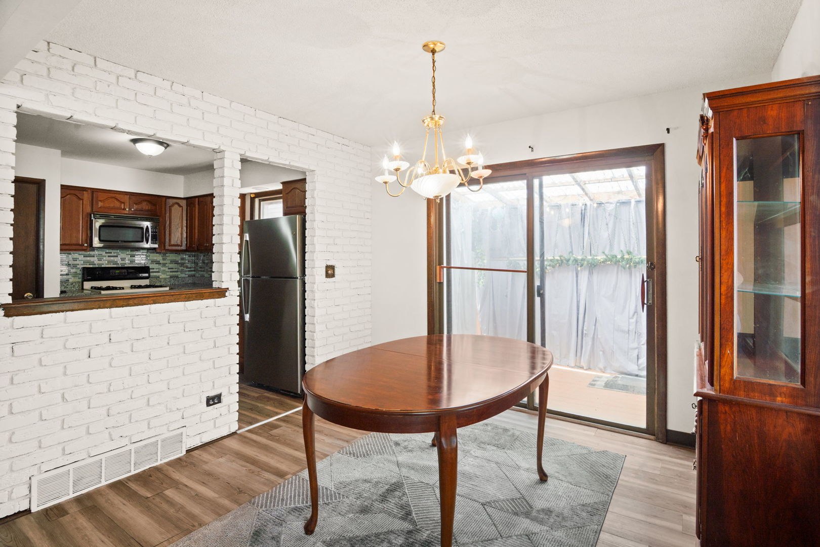 S064 Calvin Court Wheaton, IL 60187 - Photo 8 of 25 a view of a dining room with furniture window and wooden floor