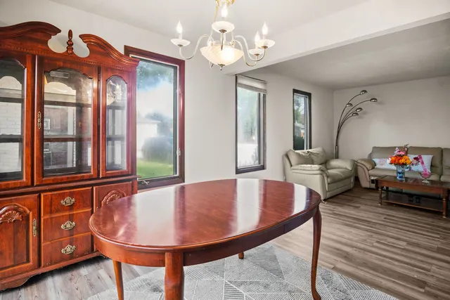 a living room with furniture a window and a chandelier
