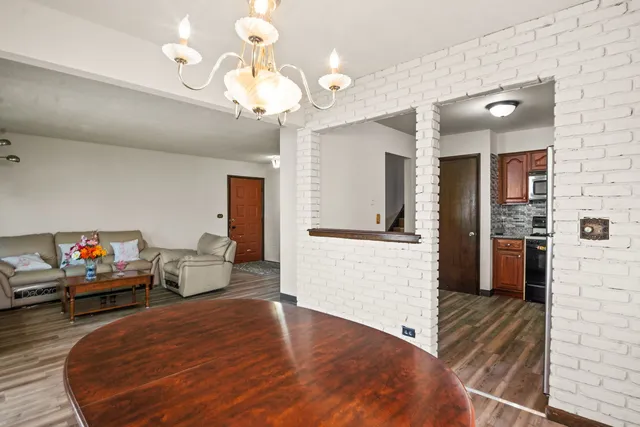 a living room with furniture and a chandelier