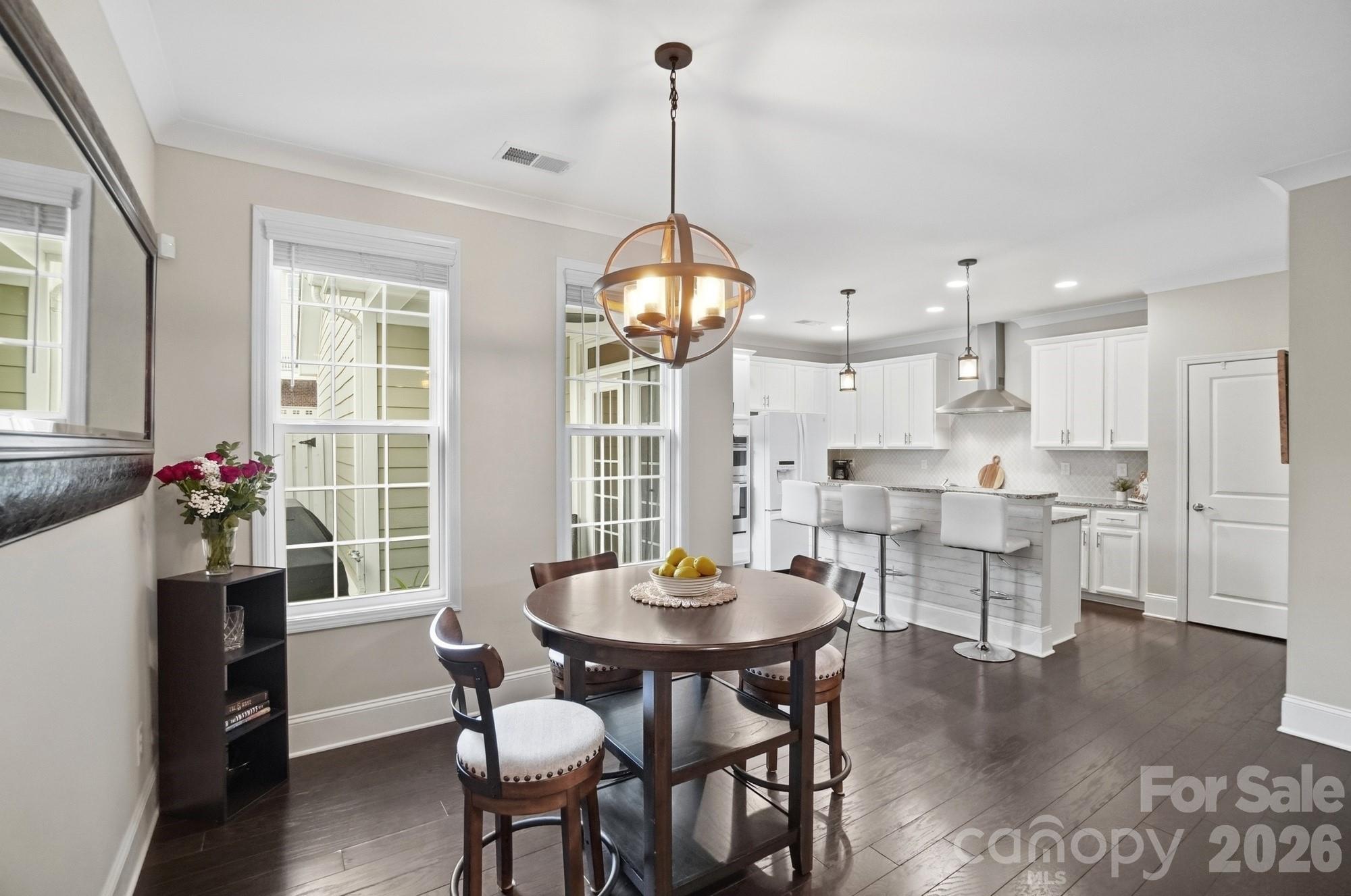6270 Hove Road Mint Hill, NC 28227 - Photo 11 of 46 a dining room with furniture a window and a chandelier
