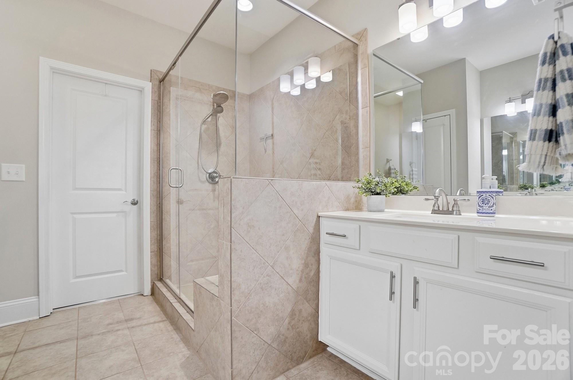 6270 Hove Road Mint Hill, NC 28227 - Photo 26 of 46 a bathroom with a shower sink and mirror
