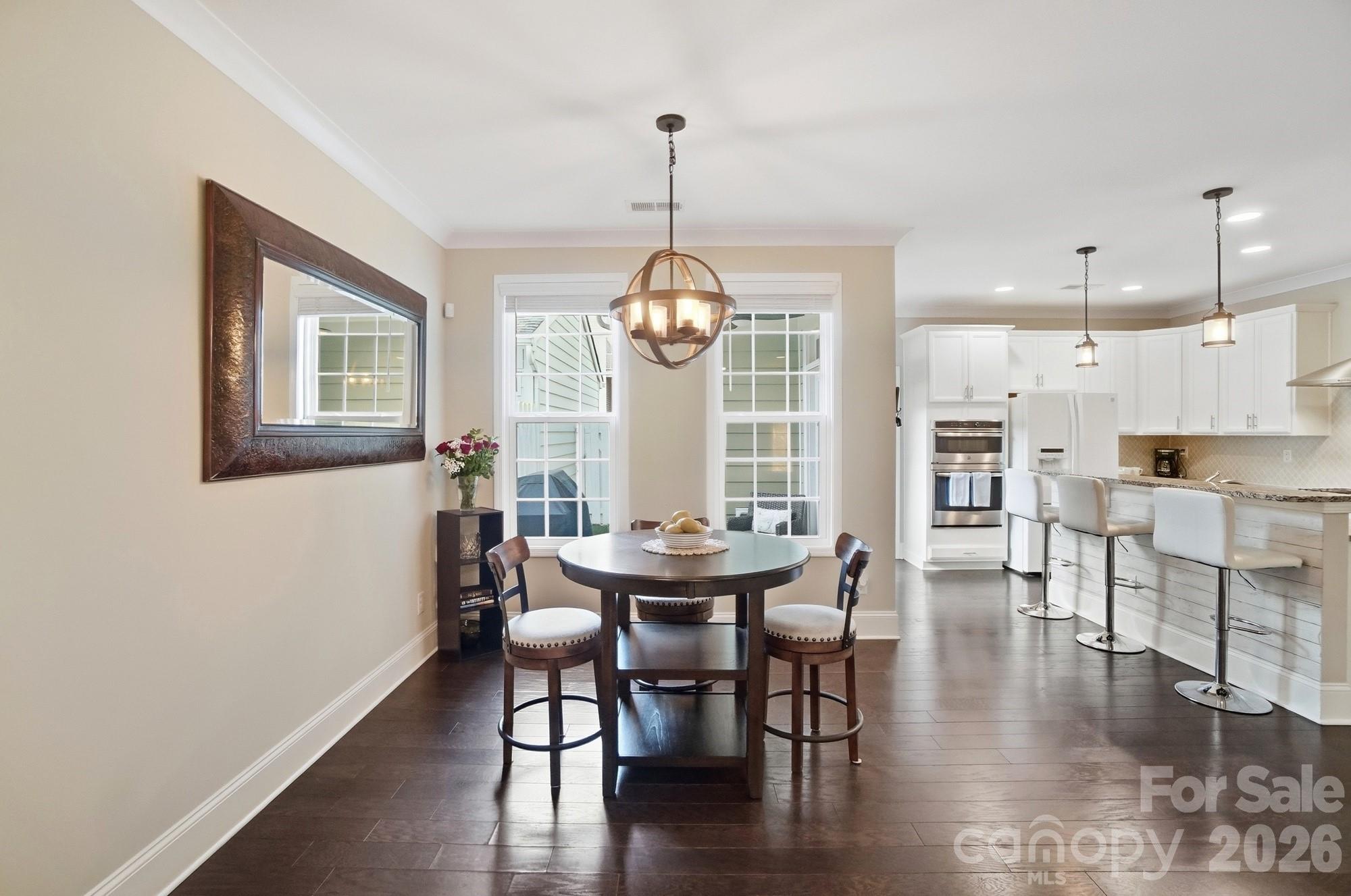 6270 Hove Road Mint Hill, NC 28227 - Photo 10 of 46 a view of a dining room with furniture window and wooden floor