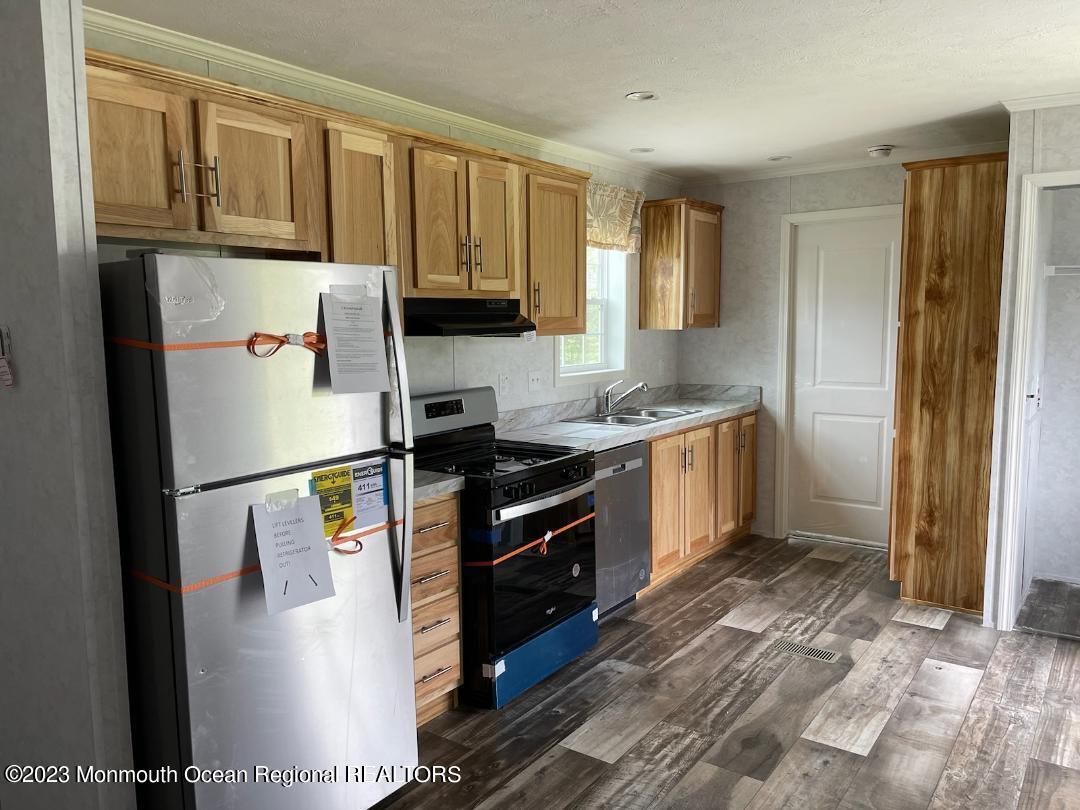 46 Jones Mill Road, Unit 101 Wrightstown, NJ 08562 - Photo 2 of 3 a kitchen with stainless steel appliances granite countertop a refrigerator a stove a sink and a window