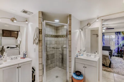 a bathroom with a shower sink and mirror