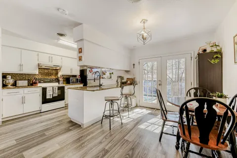 a view of a dining room with furniture window and wooden floor