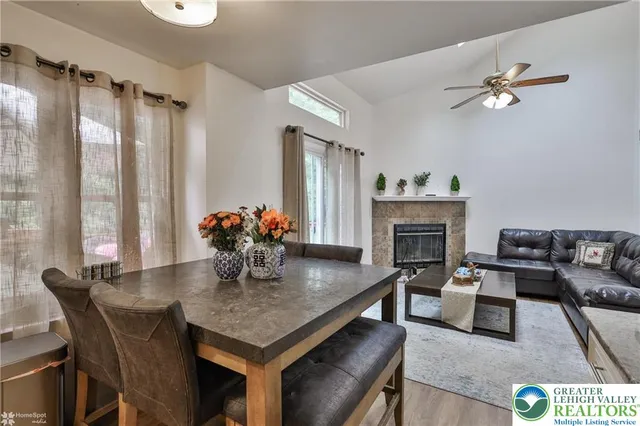 a kitchen with stainless steel appliances granite countertop a stove refrigerator a sink dishwasher with a dining table and chairs