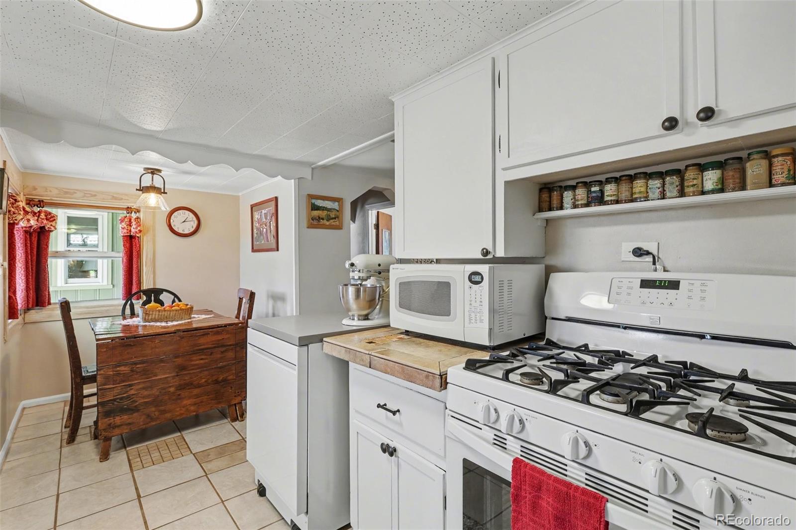 9795 Morrison Road Lakewood, CO 80227 - Photo 11 of 27 a kitchen with stainless steel appliances granite countertop a stove and a cabinets