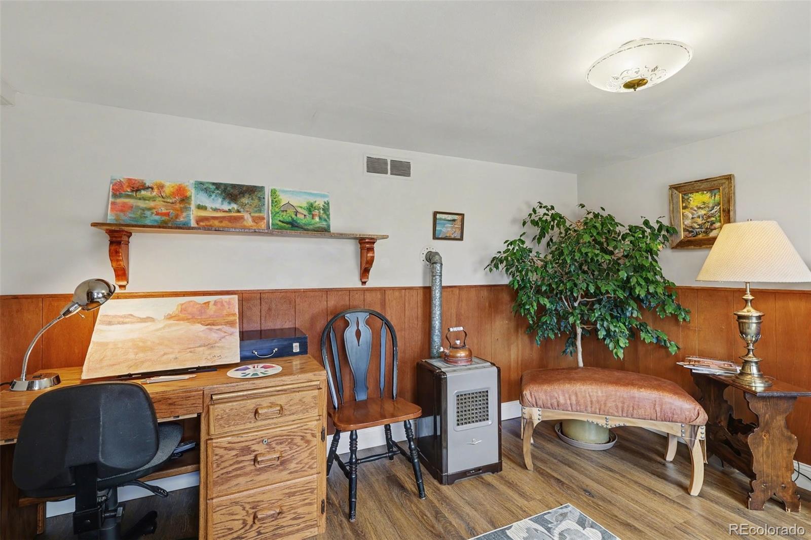 9795 Morrison Road Lakewood, CO 80227 - Photo 12 of 27 a bedroom with a bed and a potted plant on the dresser