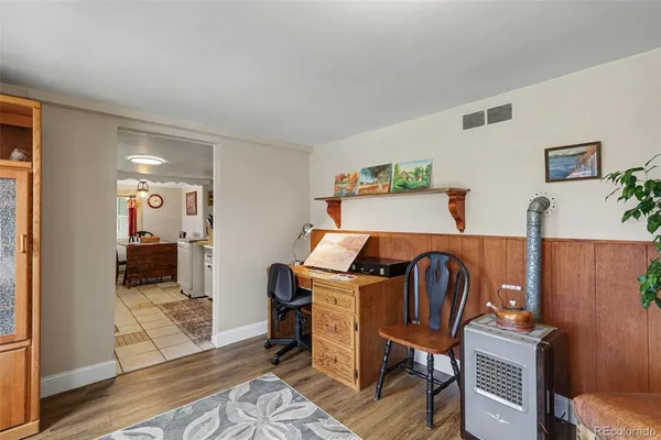 a view of a workspace with furniture and wooden floor