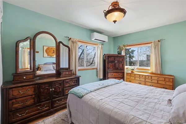a bedroom with a bed and a dresser
