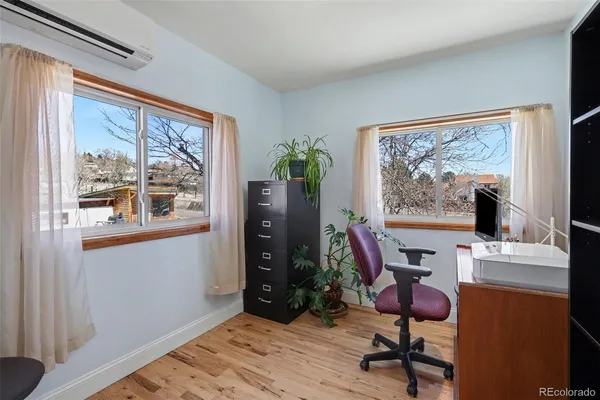a view of a workspace with furniture and a window