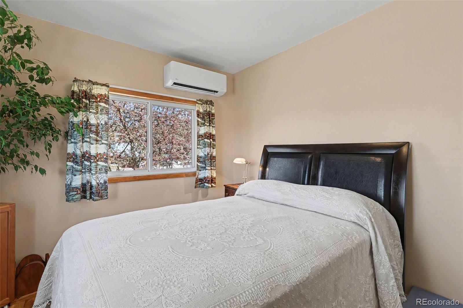 9795 Morrison Road Lakewood, CO 80227 - Photo 17 of 27 a bedroom with a bed and window