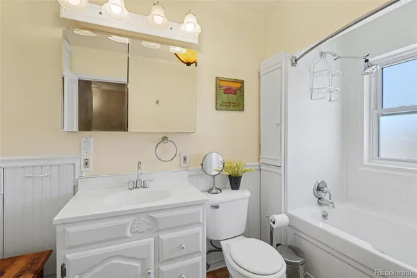 a bathroom with a sink toilet a mirror and shower