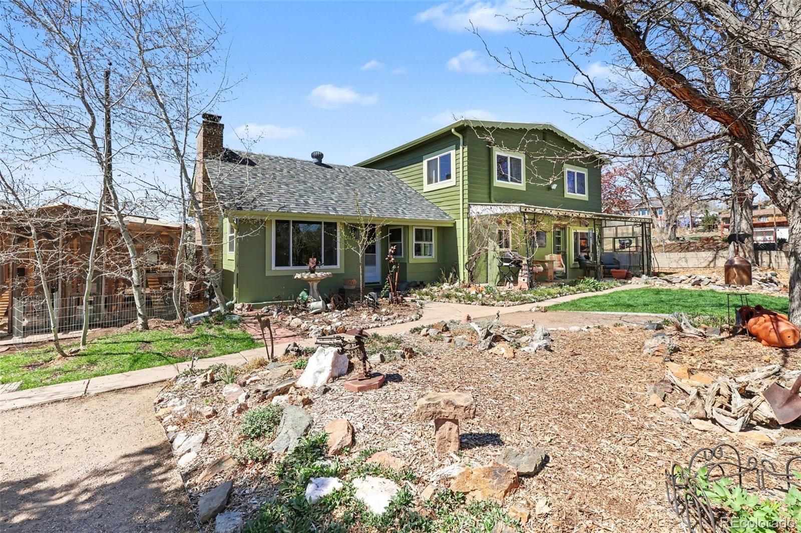 9795 Morrison Road Lakewood, CO 80227 - Photo 3 of 27 a front view of a house with a yard