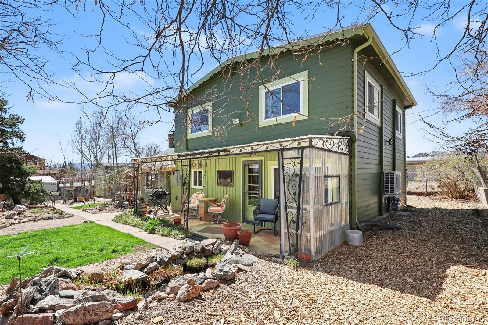 9795 Morrison Road Lakewood, CO 80227 - Photo 4 of 27 a front view of a house with garden