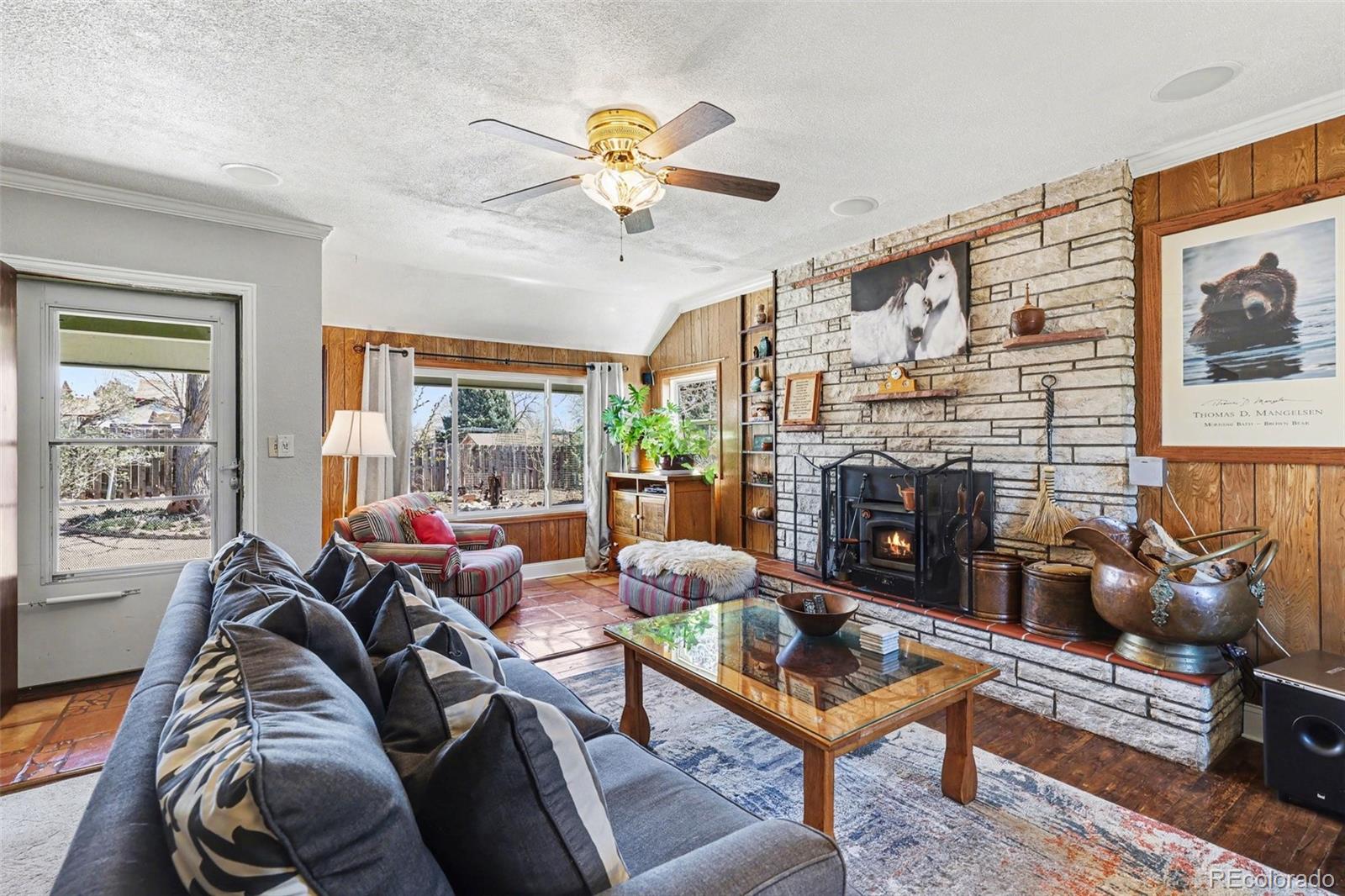 9795 Morrison Road Lakewood, CO 80227 - Photo 6 of 27 a living room with furniture a fireplace and a large window