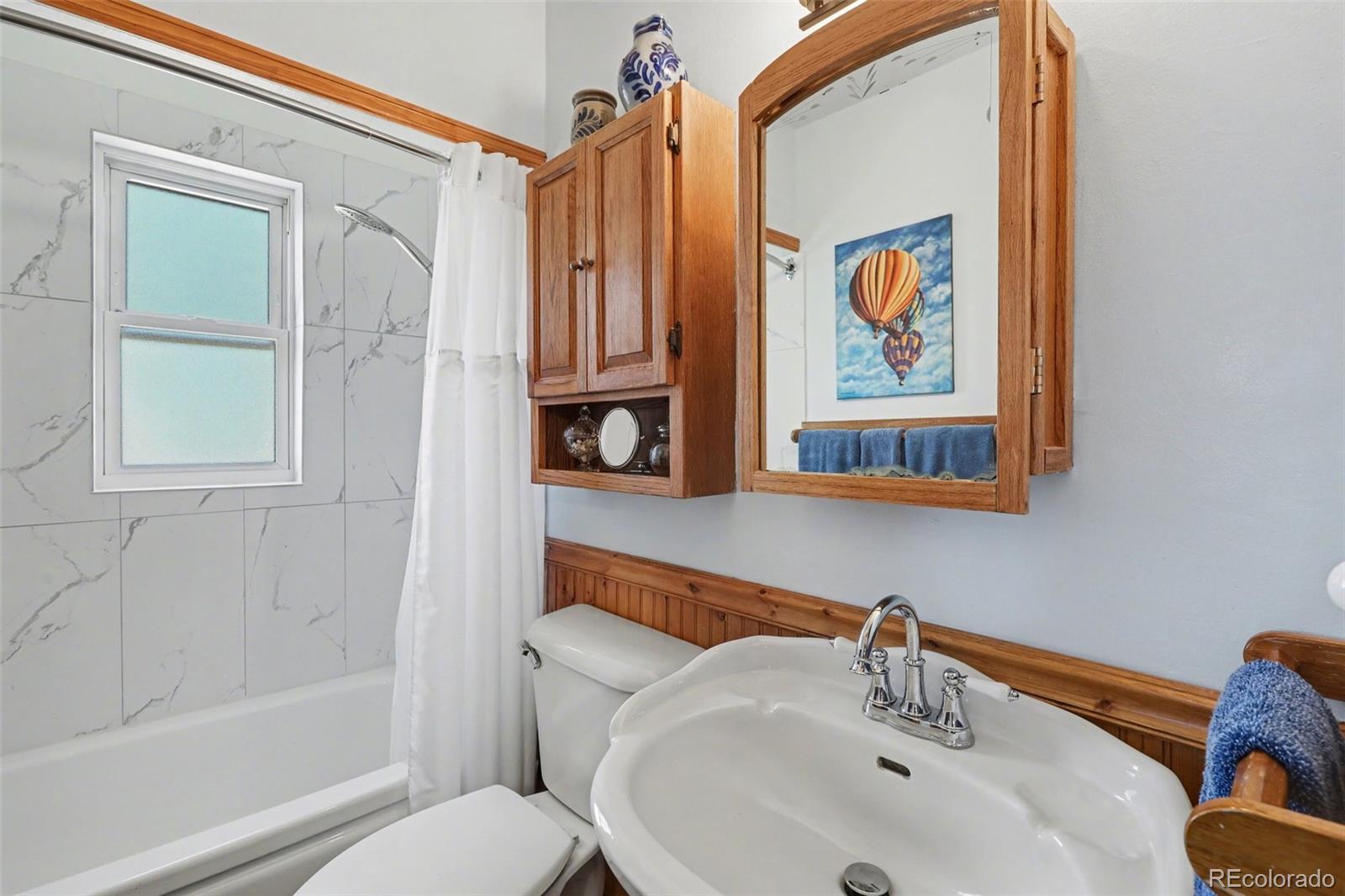 9795 Morrison Road Lakewood, CO 80227 - Photo 7 of 27 a bathroom with a sink and a mirror