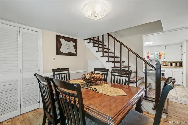 a view of a dining room with furniture and a chandelier