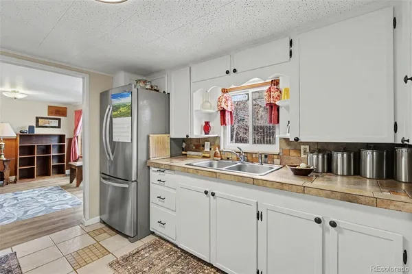 a kitchen with refrigerator and cabinets