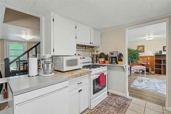 a kitchen with sink cabinets and stove top oven