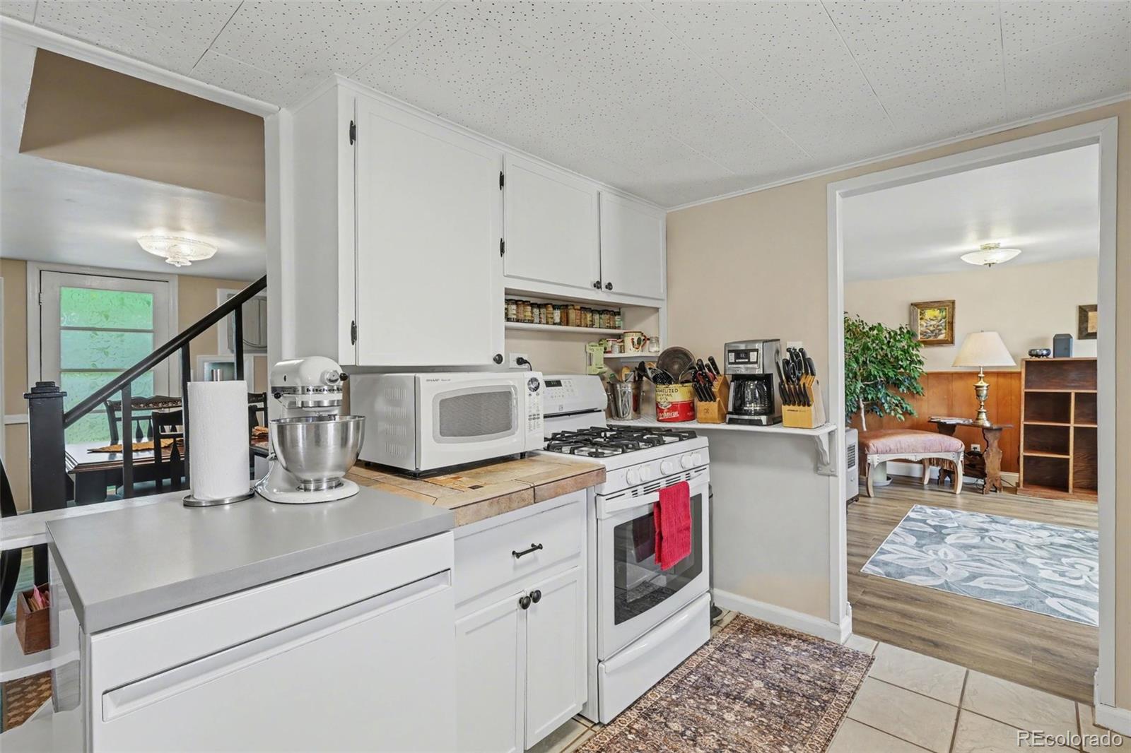 9795 Morrison Road Lakewood, CO 80227 - Photo 10 of 27 a kitchen with sink cabinets and stove top oven
