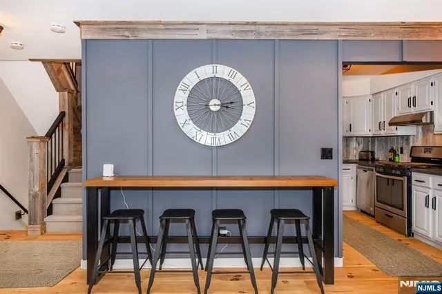 a kitchen with stainless steel appliances granite countertop a stove sink and cabinets