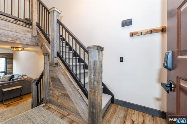 a view of a hallway with wooden floor and entryway