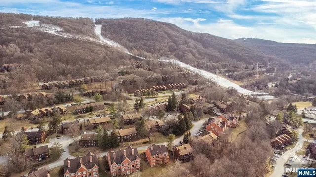 a living room with fireplace furniture and a flat screen tv