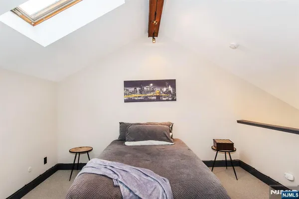 a bedroom with furniture and a large window