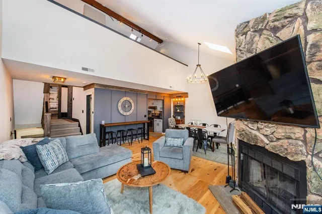 a living room with furniture a fireplace and a flat screen tv