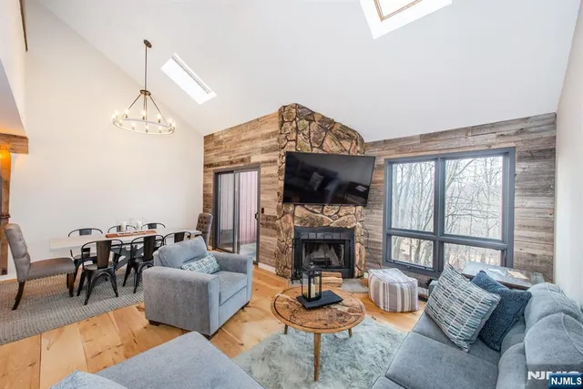 a living room with furniture a fireplace and a chandelier