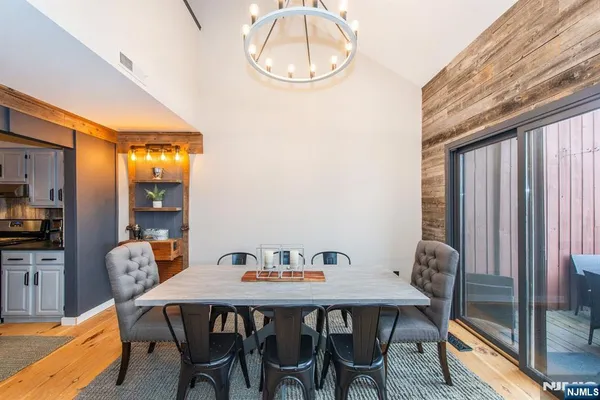 a view of a dining room with furniture and a chandelier