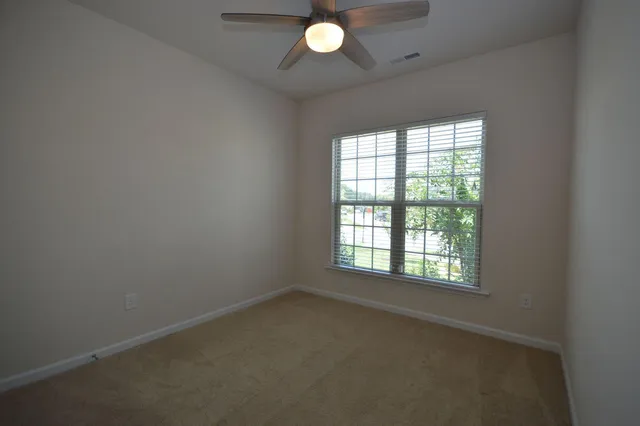 a view of an empty room and a window