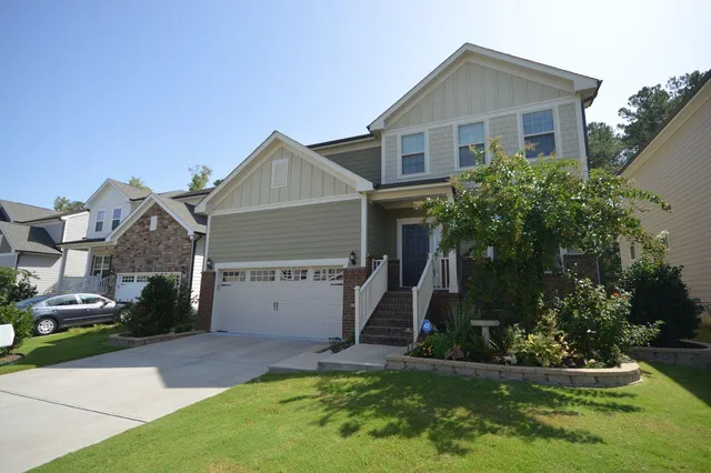a view of a hallway with wooden floor and windows