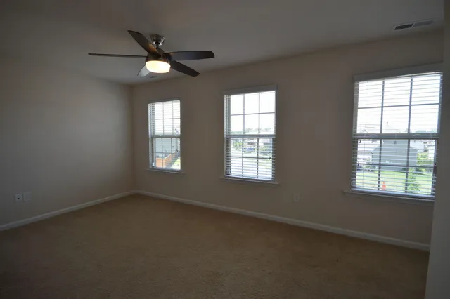 a view of empty room with ceiling fan