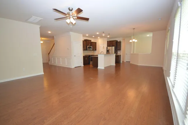 a kitchen with stainless steel appliances granite countertop a sink refrigerator and microwave