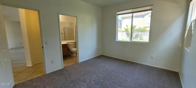 an empty room with windows and closet