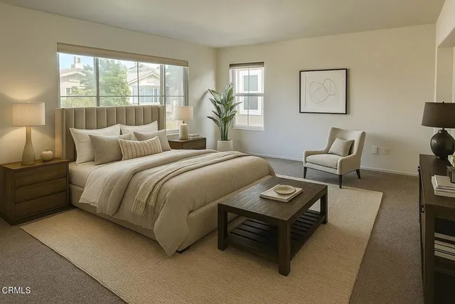 a bedroom with furniture and a large window