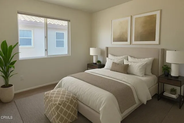 a bedroom with a bed and a potted plant