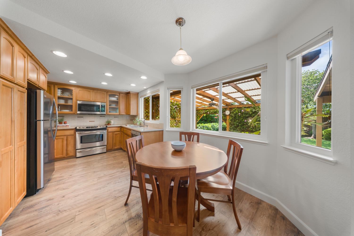 1325 Forest Drive Turlock, CA 95380 - Photo 1 of 28 a kitchen with a table chairs refrigerator and cabinets
